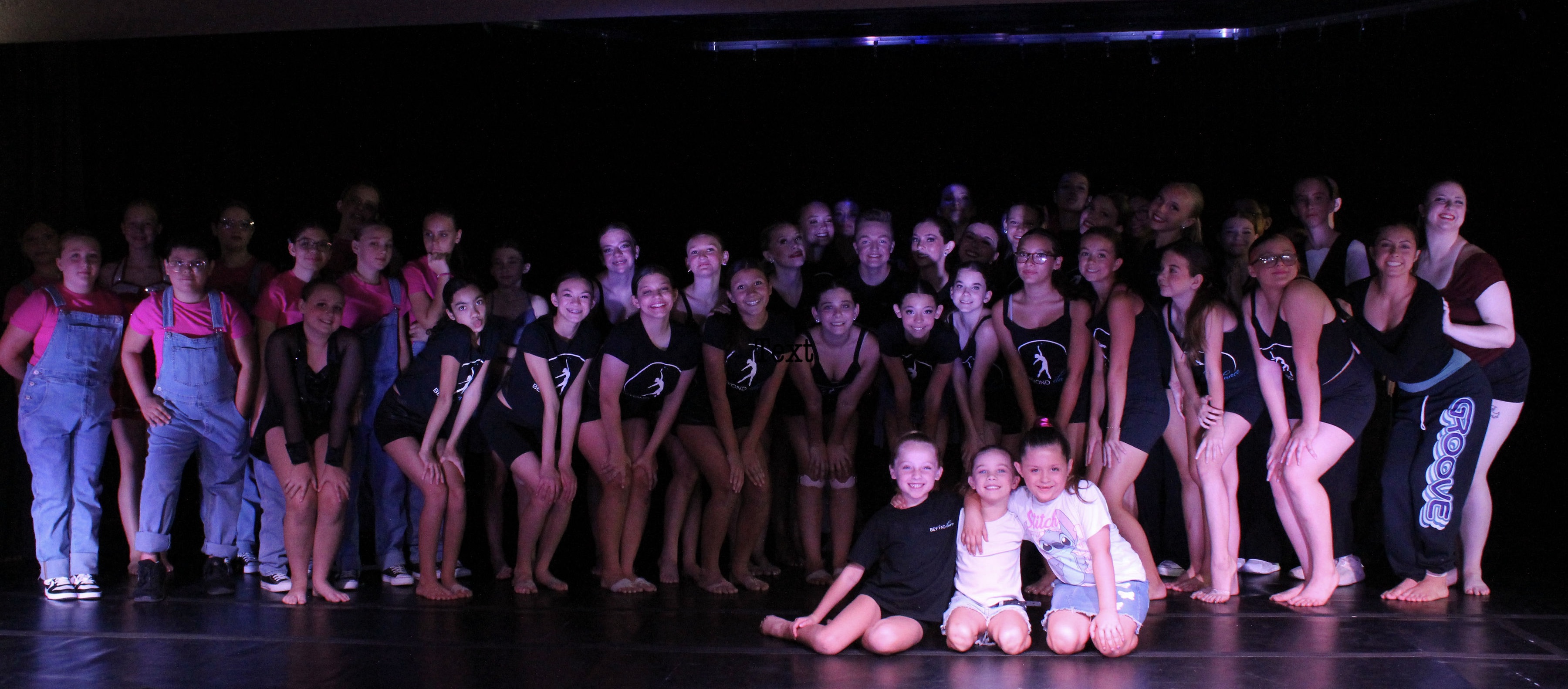 Beyond Dance dancers and staff gathered on stage after a performance